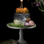 A fall hazelnut ombre cake with flowers and candles.