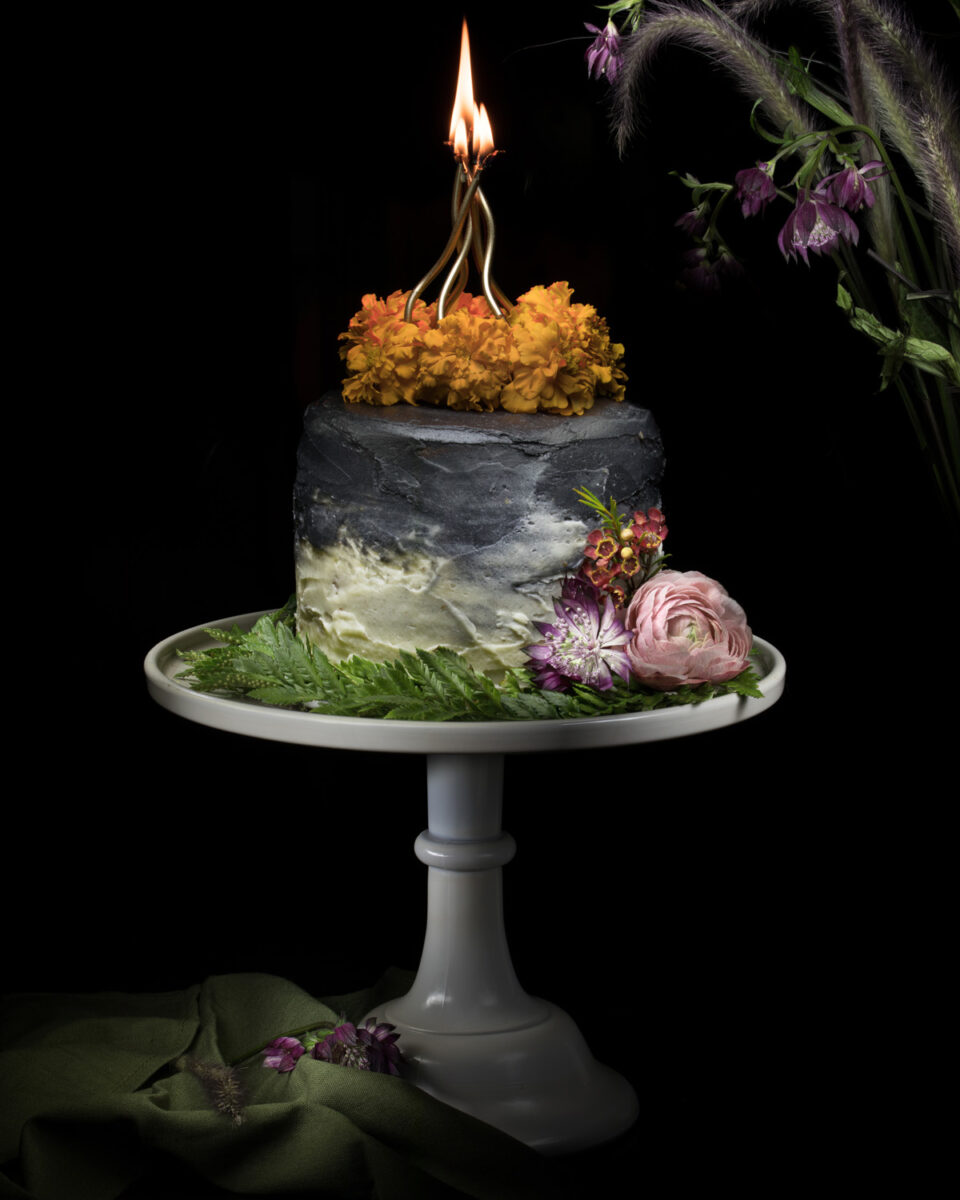A fall hazelnut ombre cake with flowers and candles.